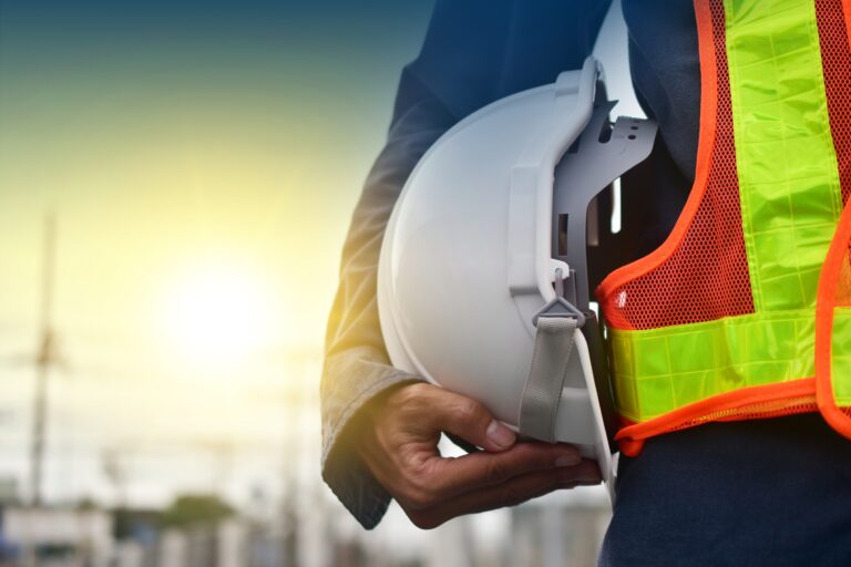 Technician holding white hat safety hard hat sunlight background